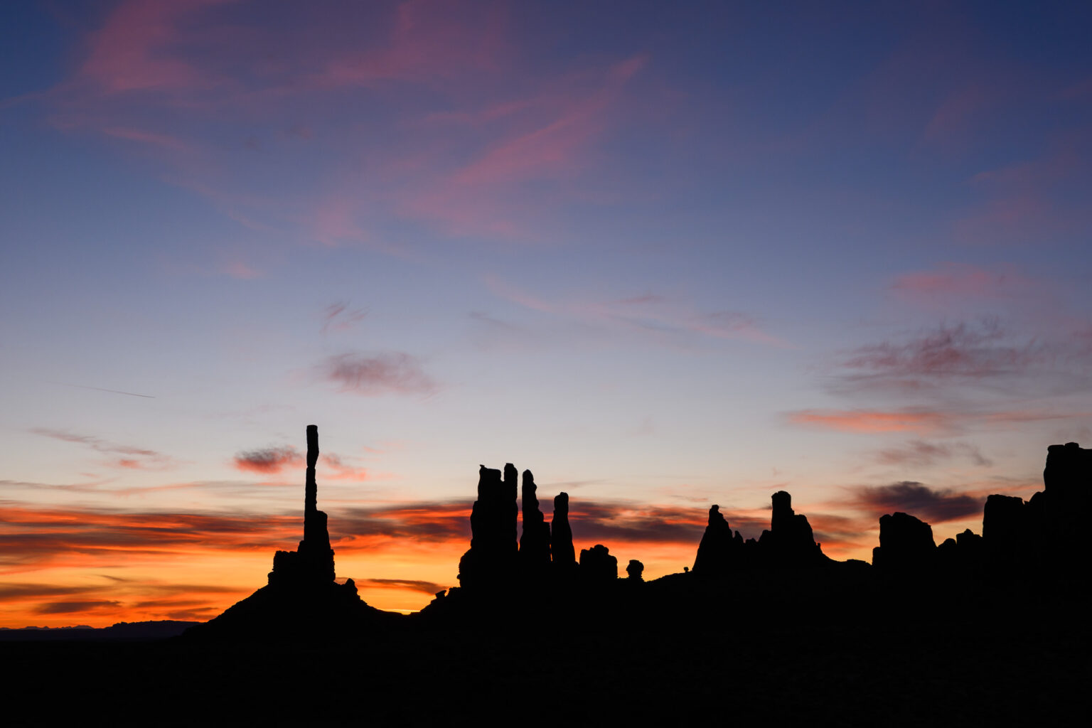 Sunrise over Totem Pole and Yei Bi Chei in Monument Valley