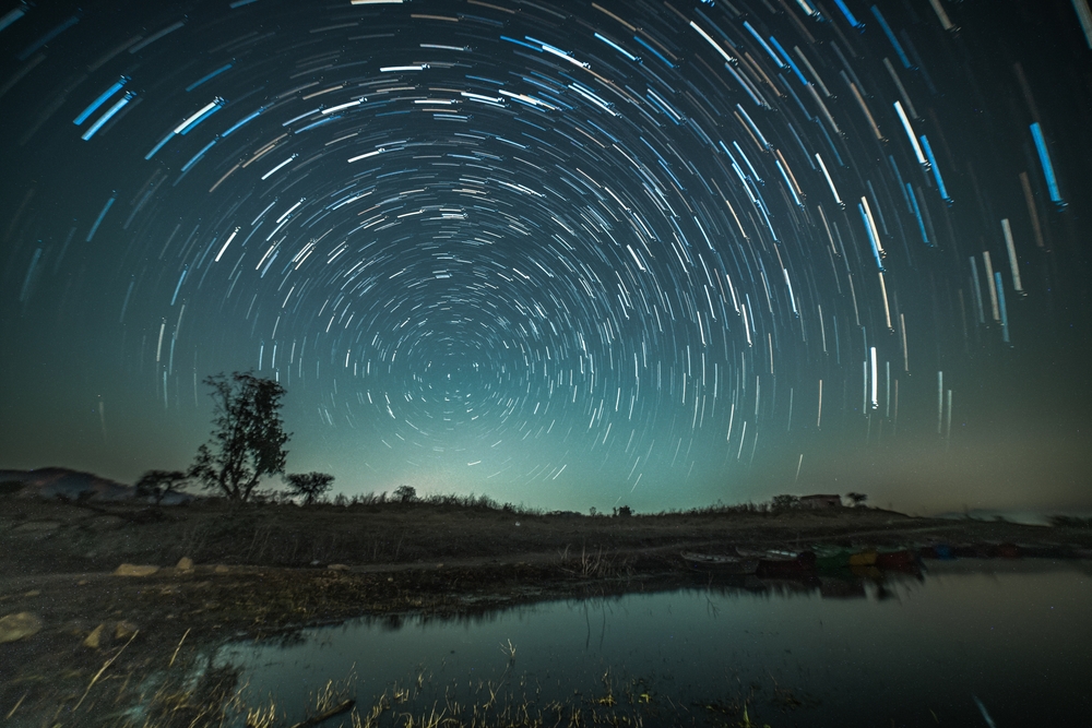 Circular star trails over a lake