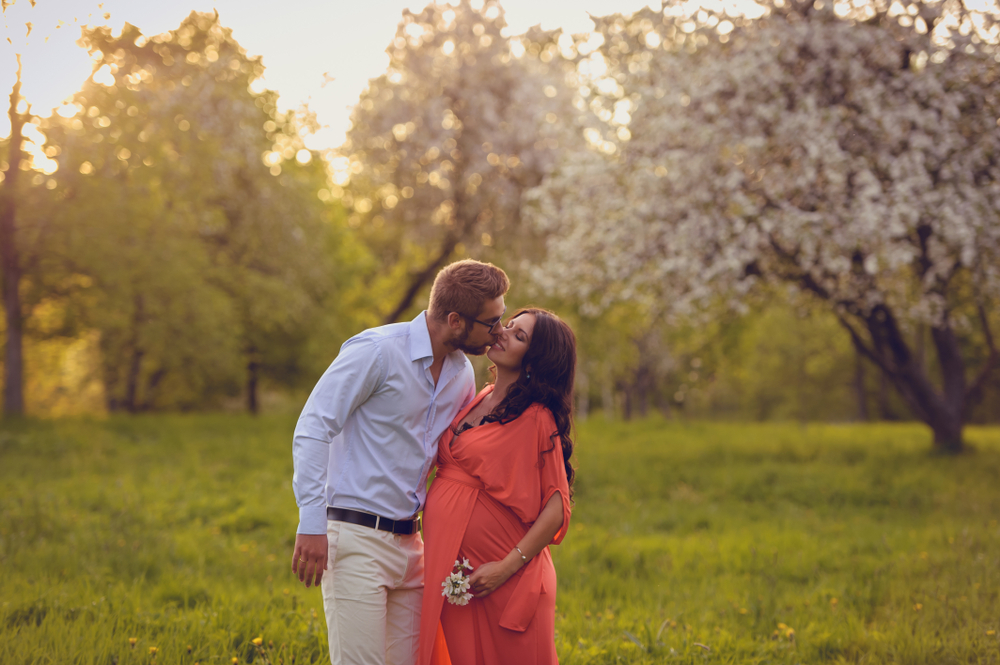 Maternity Photo of Couple in a blooming orchard