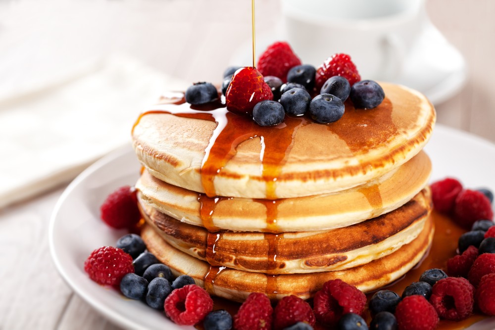 Pancakes with berries and maple syrup