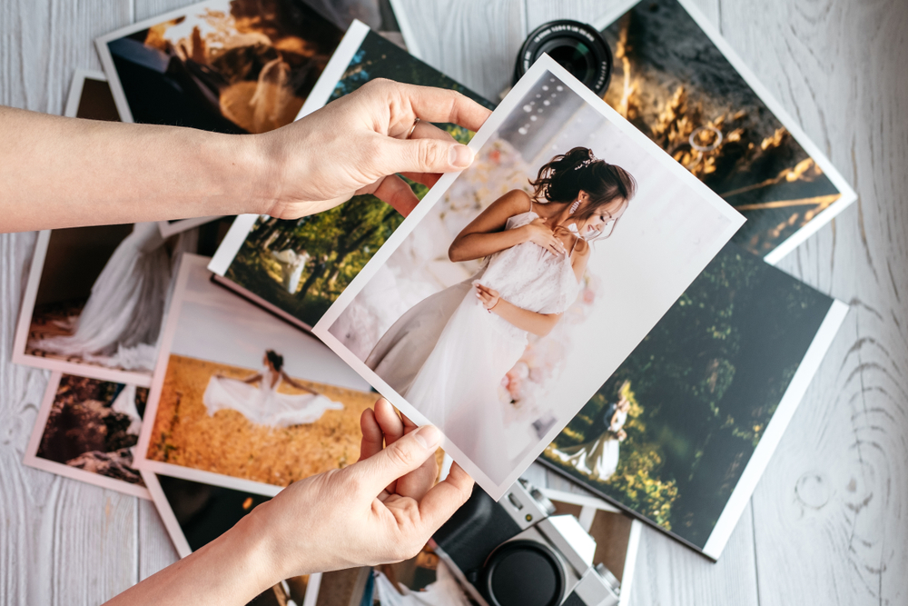 person holding Printed wedding photos