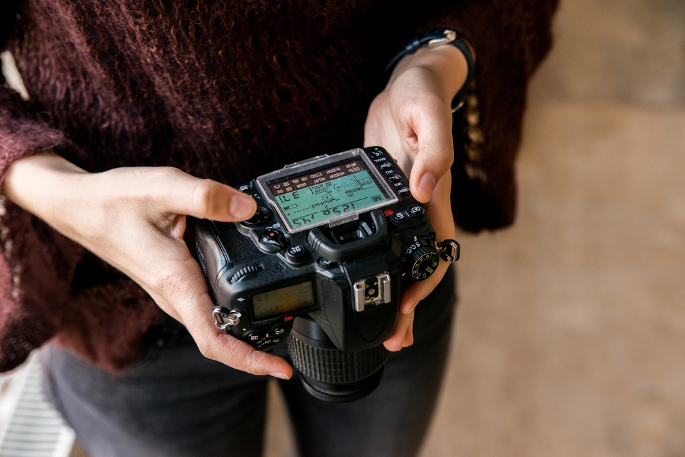 photographer adjusting camera settings