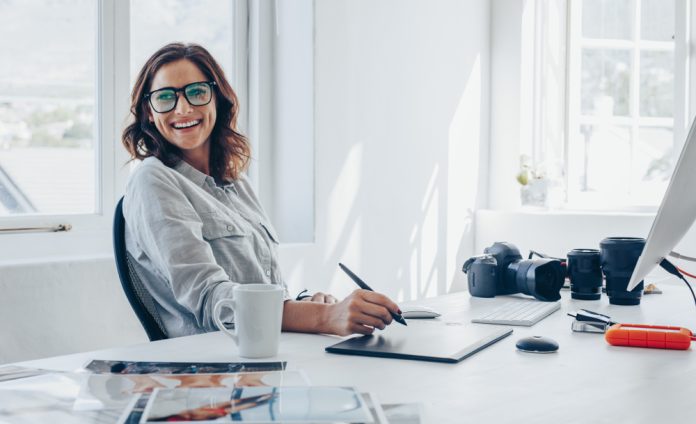 photographer sitting at her office desk