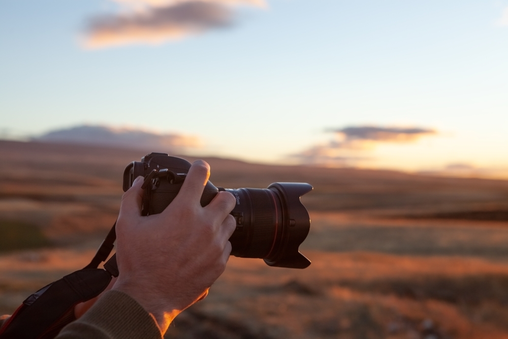 Photographer's hands on a camera