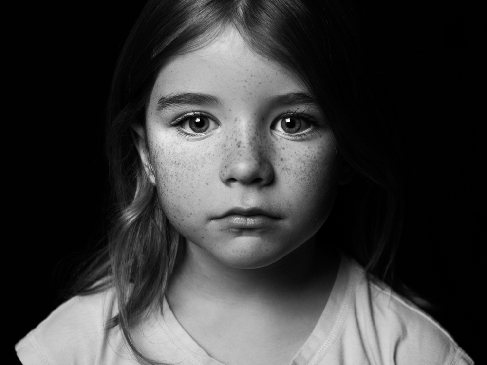 portrait of a young girl with freckles BW