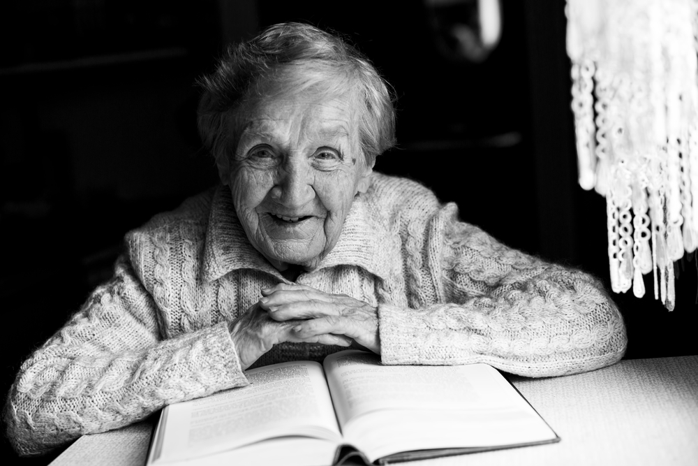 Portrait of an old woman reading a book