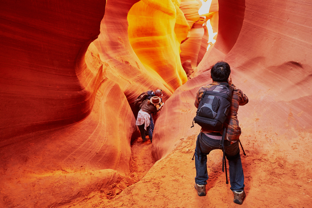 Tourist taking photo in Lower Antelope Canyon in the Navajo Reservation near Page, Arizona, USA