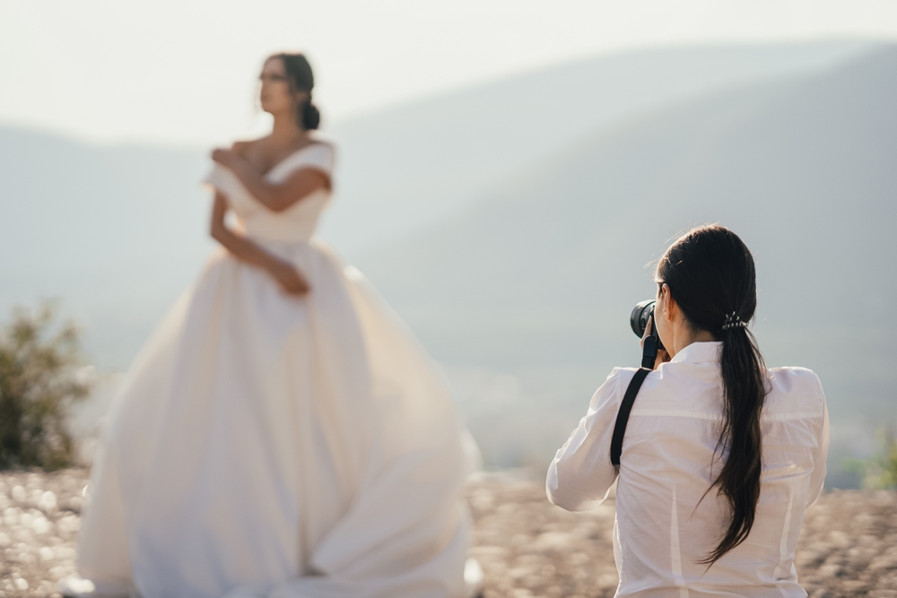 wedding photographer taking pictures of a bride