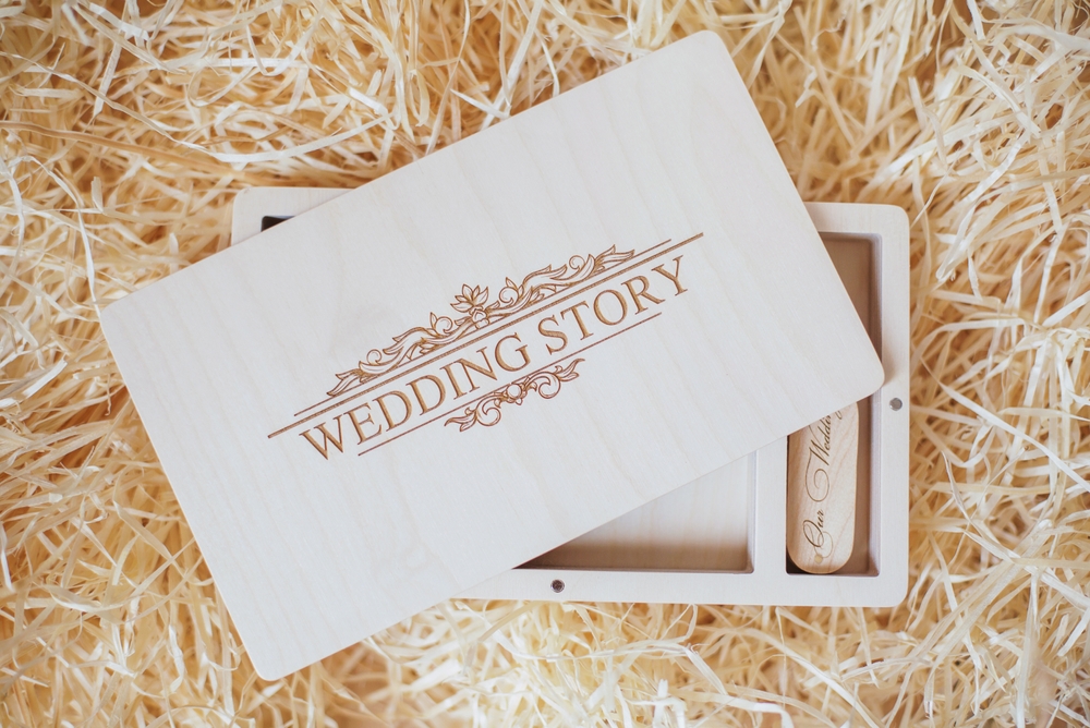 Wooden photo box for photo storage on straw background