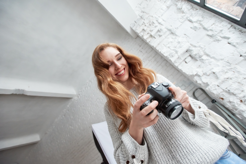 young female photographer with dslr